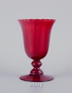 A set of six large wine glasses in red glass. Sweden. Late 20th century